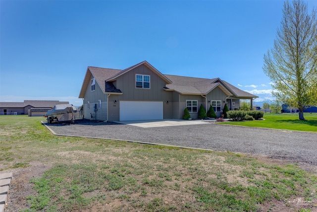 7175 Bootlegger Dr, Helena, MT 59602 - view of front of home with driveway, board and batten siding, an attached garage, and a front lawn