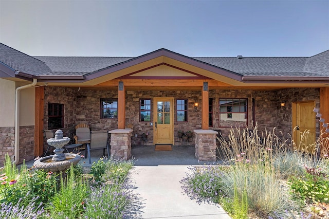 470 Salmon Way, Corvallis, MT 59828 - entrance to property featuring a shingled roof, stone siding, and a porch