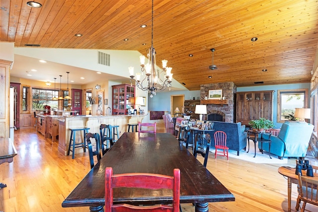 470 Salmon Way, Corvallis, MT 59828 - dining room with vaulted ceiling, light wood-style flooring, recessed lighting, wooden ceiling, and a fireplace