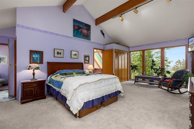 bedroom with light carpet, beam ceiling, rail lighting, high vaulted ceiling, and a closet