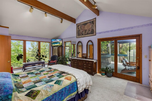 carpeted bedroom with track lighting, access to outside, beam ceiling, multiple windows, and high vaulted ceiling