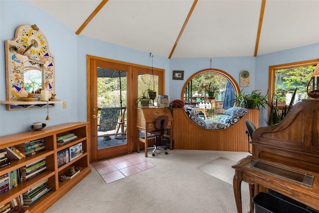 carpeted office space featuring french doors and vaulted ceiling