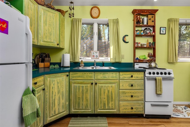 kitchen featuring white appliances, a sink, dark countertops, dark wood-style flooring, and open shelves