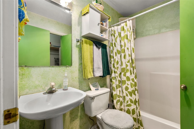 bathroom featuring toilet, a sink, and shower / bathtub combination with curtain