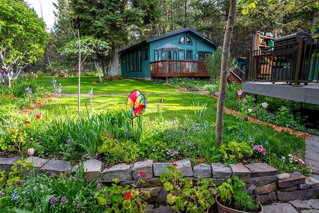 view of green lawn featuring a deck