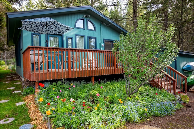 back of property with a wooden deck