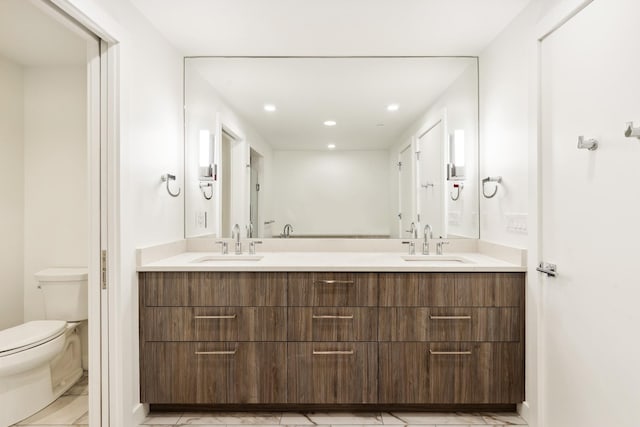 315 N Tracy Ave Unit 404, Bozeman, MT 59715 - bathroom with marble look tiles, toilet, double vanity, and recessed lighting