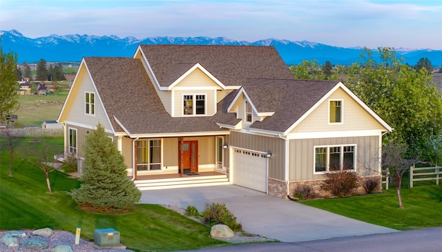 125 Schlegel View Rd, Kalispell, MT 59901 - craftsman-style house featuring a mountain view, driveway, stone siding, a shingled roof, and board and batten siding
