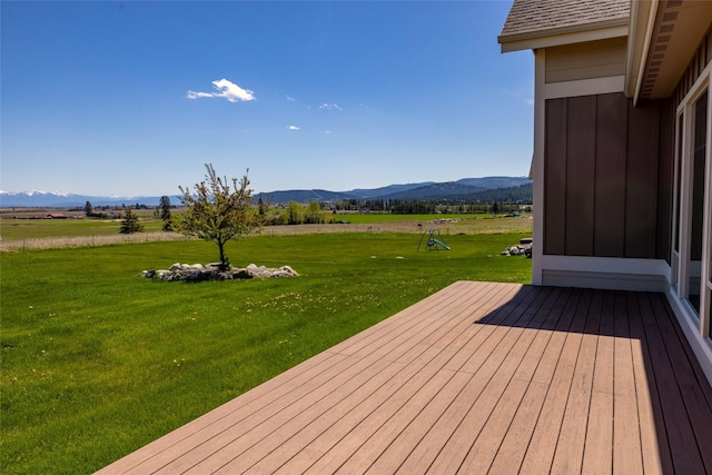 125 Schlegel View Rd, Kalispell, MT 59901 - wooden terrace with a mountain view, a lawn, and a view of countryside