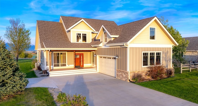 125 Schlegel View Rd, Kalispell, MT 59901 - view of front of property with concrete driveway, an attached garage, a shingled roof, board and batten siding, and a porch