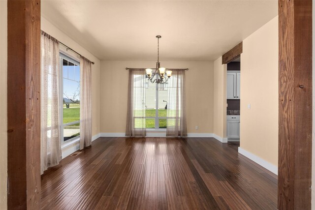 125 Schlegel View Rd, Kalispell, MT 59901 - unfurnished dining area featuring a chandelier, dark wood-type flooring, and baseboards