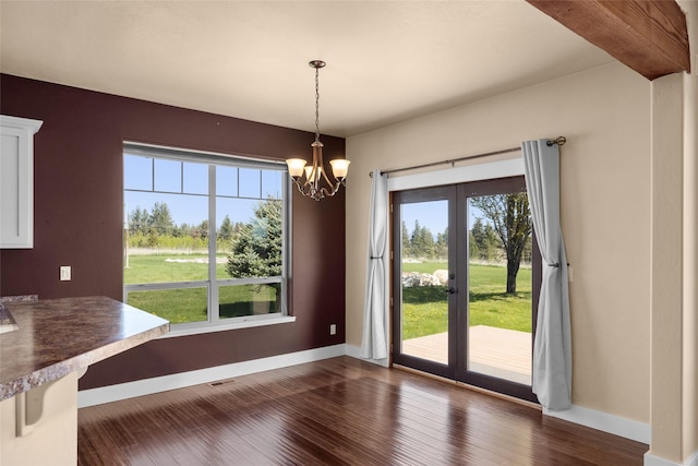 125 Schlegel View Rd, Kalispell, MT 59901 - unfurnished dining area with french doors, baseboards, a chandelier, and dark wood-type flooring