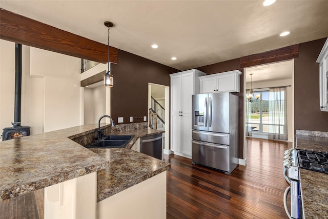 125 Schlegel View Rd, Kalispell, MT 59901 - kitchen with stainless steel appliances, a sink, dark wood finished floors, recessed lighting, and white cabinets