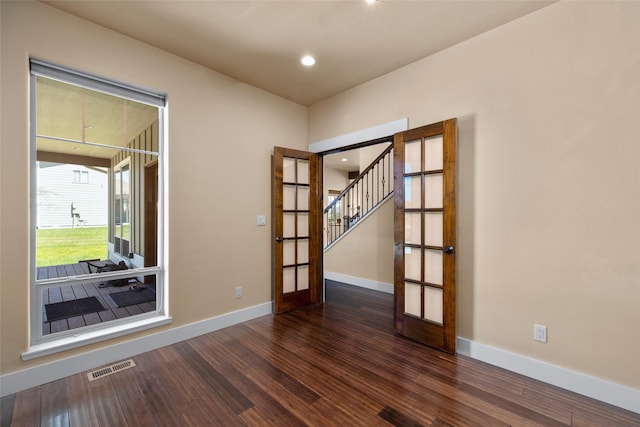 125 Schlegel View Rd, Kalispell, MT 59901 - empty room featuring french doors, dark wood finished floors, stairs, and recessed lighting