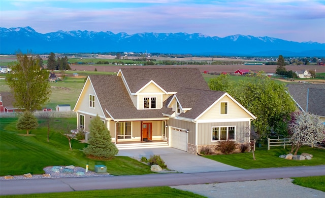 125 Schlegel View Rd, Kalispell, MT 59901 - view of front of house with stone siding, a mountain view, and a front yard