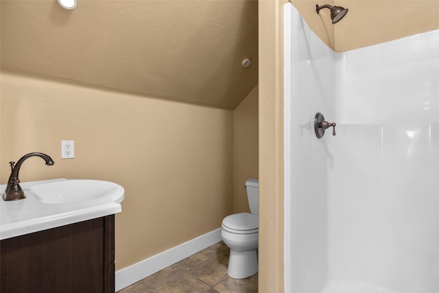 125 Schlegel View Rd, Kalispell, MT 59901 - full bathroom featuring vaulted ceiling, a shower, vanity, and tile patterned flooring