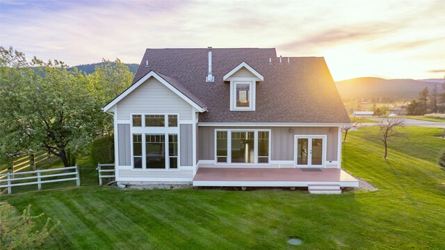 125 Schlegel View Rd, Kalispell, MT 59901 - rear view of house featuring a deck with mountain view, roof with shingles, and french doors