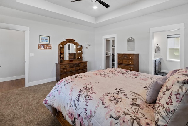 131 Owl Loop, Kalispell, MT 59901 - carpeted bedroom with a spacious closet, a raised ceiling, ceiling fan, a closet, and ensuite bath