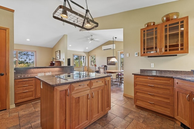 240 Eagle Bend Dr, Bigfork, MT 59911 - kitchen featuring black electric cooktop, a wall mounted AC, plenty of natural light, stone tile flooring, and lofted ceiling