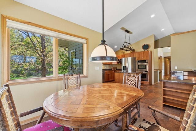 240 Eagle Bend Dr, Bigfork, MT 59911 - dining room featuring vaulted ceiling, stone tile floors, and recessed lighting