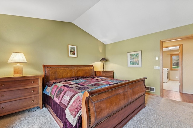 240 Eagle Bend Dr, Bigfork, MT 59911 - bedroom featuring washer and clothes dryer, carpet flooring, and vaulted ceiling