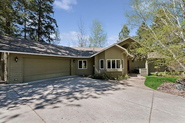 240 Eagle Bend Dr, Bigfork, MT 59911 - single story home with driveway, an attached garage, and roof with shingles