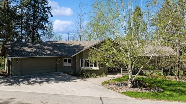 240 Eagle Bend Dr, Bigfork, MT 59911 - view of front of property with a garage, driveway, and roof with shingles