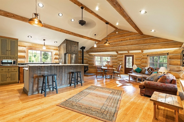 4991 Petty Creek Rd, Alberton, MT 59820 - living area with log walls, light wood-style flooring, a wood stove, and recessed lighting