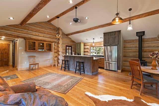 living area featuring log walls, light wood-style floors, a wood stove, baseboards, and recessed lighting