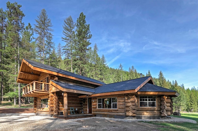 4991 Petty Creek Rd, Alberton, MT 59820 - cabin with log exterior, roof with shingles, and a view of trees