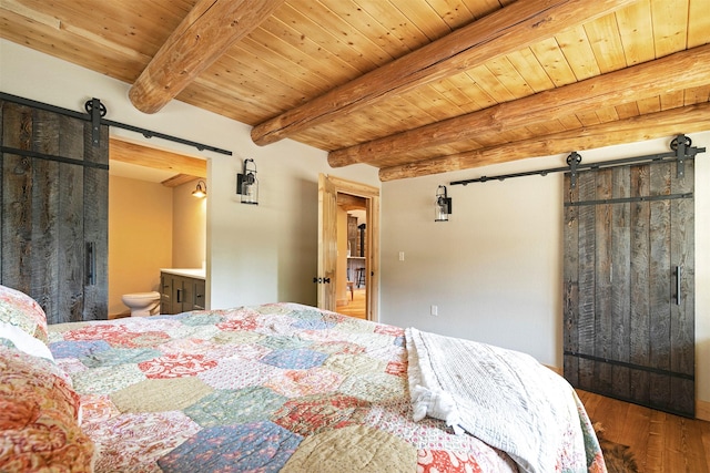 bedroom featuring a barn door, wood finished floors, wooden ceiling, beam ceiling, and ensuite bathroom