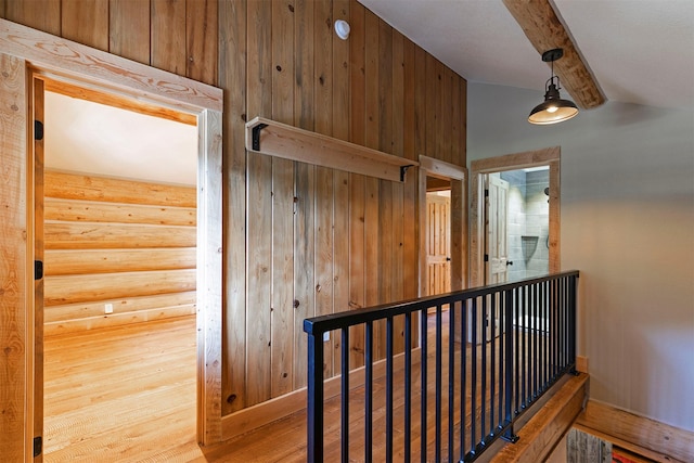 hall featuring rustic walls, wood finished floors, and a sauna / steam room