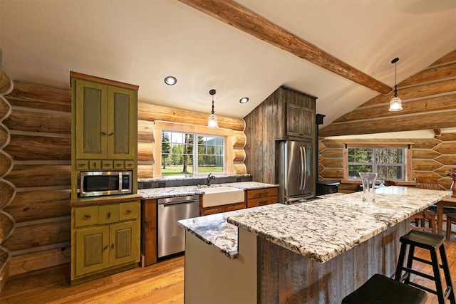 4991 Petty Creek Rd, Alberton, MT 59820 - kitchen featuring appliances with stainless steel finishes, log walls, light wood-style flooring, light stone countertops, and hanging light fixtures