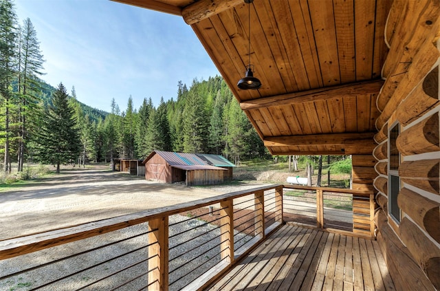 deck with a view of trees and an outdoor structure