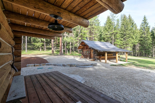view of patio / terrace featuring an outdoor structure and a wooded view