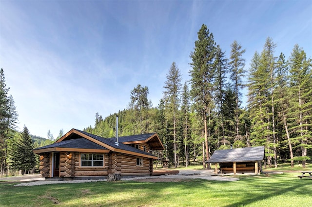 4991 Petty Creek Rd, Alberton, MT 59820 - view of front of property featuring log exterior, a front yard, and a view of trees