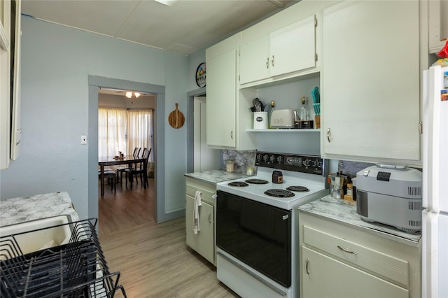 4 Ratcliff Rd, Hot Springs, MT 59845 - kitchen featuring electric range oven, tasteful backsplash, light wood-style floors, open shelves, and freestanding refrigerator