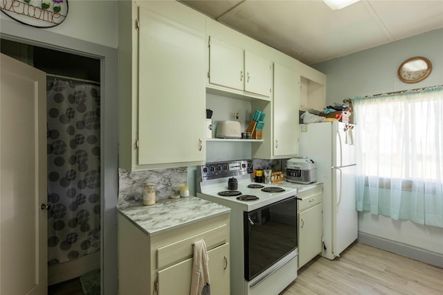 4 Ratcliff Rd, Hot Springs, MT 59845 - kitchen with white appliances, light countertops, open shelves, light wood-style flooring, and decorative backsplash