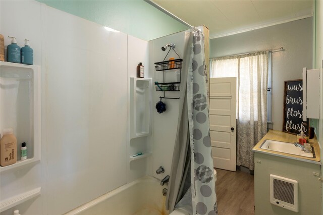 4 Ratcliff Rd, Hot Springs, MT 59845 - full bath with wood finished floors, shower / bath combo with shower curtain, heating unit, and a sink