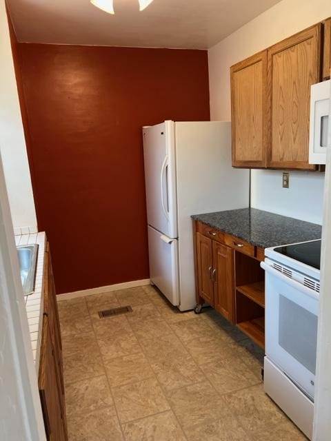 915 Hauser Blvd, Helena, MT 59601 - kitchen with white appliances, a sink, brown cabinets, and light floors