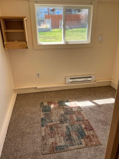 915 Hauser Blvd, Helena, MT 59601 - carpeted empty room featuring a baseboard radiator and baseboards