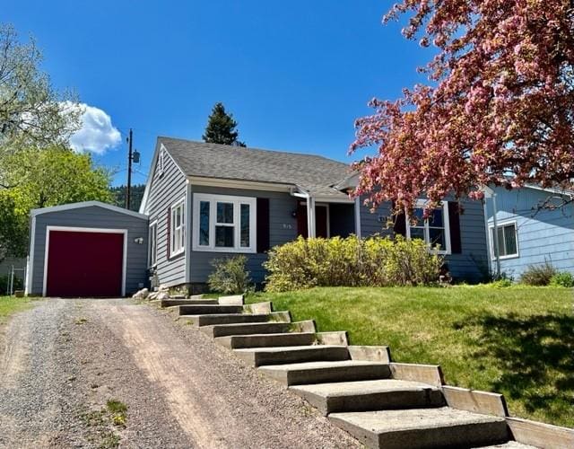 915 Hauser Blvd, Helena, MT 59601 - view of front of home featuring an outbuilding, a front yard, a garage, and driveway