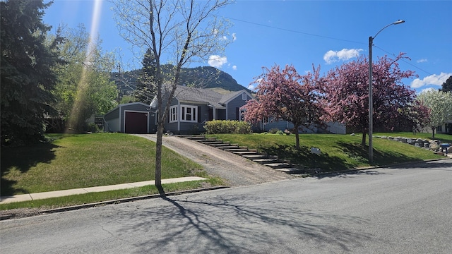 915 Hauser Blvd, Helena, MT 59601 - obstructed view of property with driveway, a front yard, a storage unit, an outbuilding, and a detached garage