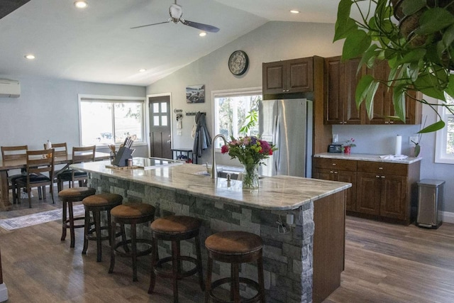 179 Fairmont Rd, Kalispell, MT 59901 - kitchen featuring stainless steel fridge, a sink, dark wood-type flooring, a breakfast bar, and a ceiling fan