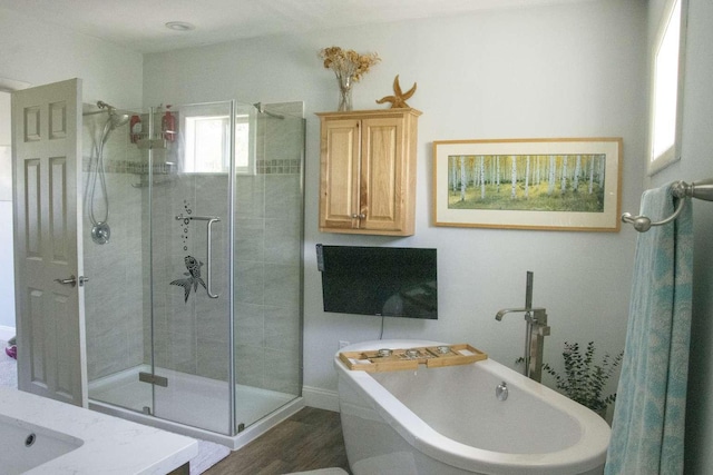 179 Fairmont Rd, Kalispell, MT 59901 - bathroom featuring a stall shower, a freestanding bath, wood finished floors, and a sink
