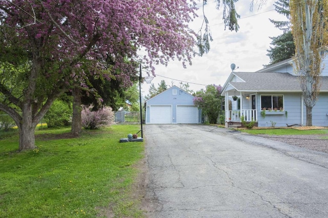 179 Fairmont Rd, Kalispell, MT 59901 - view of front of property featuring an outbuilding, a garage, a shingled roof, and covered porch