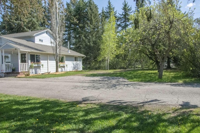 179 Fairmont Rd, Kalispell, MT 59901 - view of side of property with a porch and a lawn
