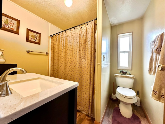 3000 Villard Ave Unit 80, Helena, MT 59601 - full bath featuring a sink, wood finished floors, toilet, a textured ceiling, and baseboards