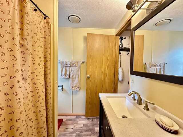 3000 Villard Ave Unit 80, Helena, MT 59601 - full bath with wood finished floors, a textured ceiling, vanity, and a shower with shower curtain