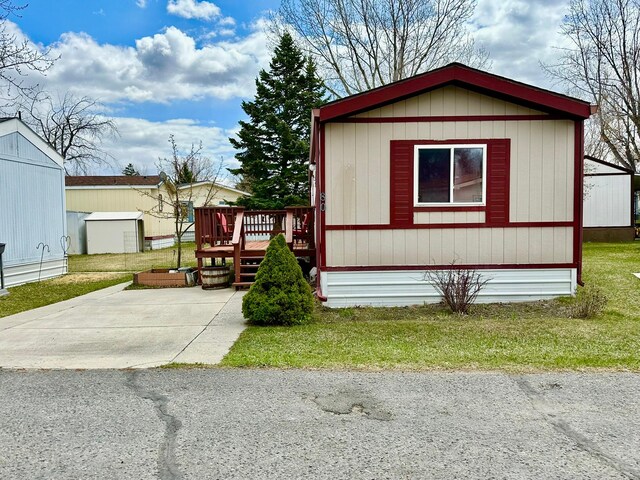 3000 Villard Ave Unit 80, Helena, MT 59601 - manufactured / mobile home featuring a wooden deck and a front lawn